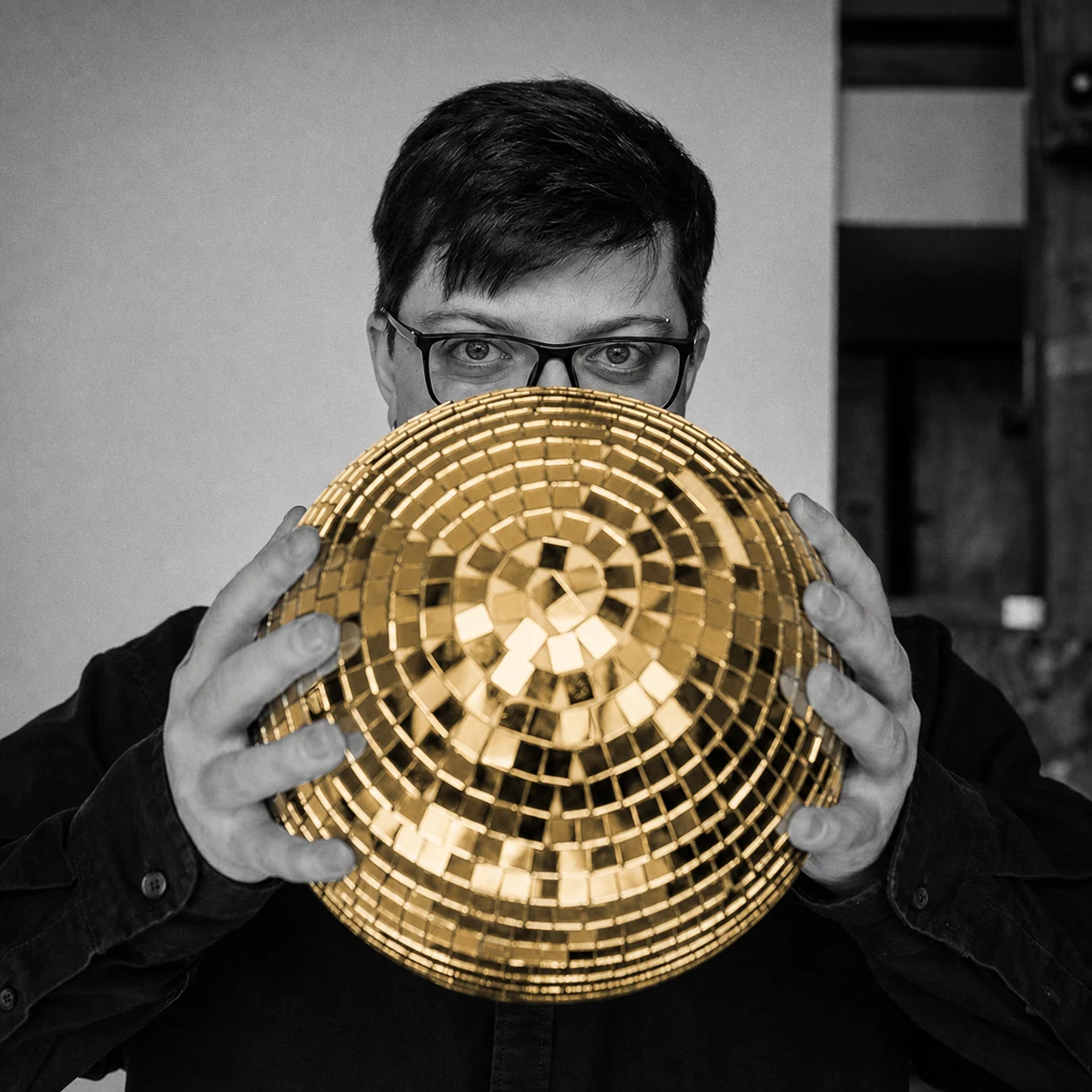 Ivan Zakutnii holding a gold mirrored sphere.